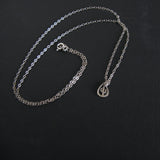 Silver necklace with a small cactus pendant on a black background