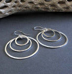Sterling silver 3 ring dangle earrings on gray background