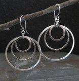 Large 3 ring silver dangle earrings hanging from branch