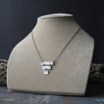 Sterling silver inverted pyramid necklace shown on tan bust