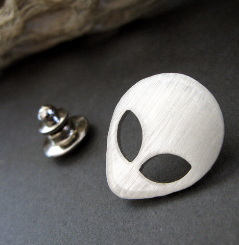 Silver Alien tie tack pin on black background