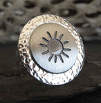 Silver sun ring with driftwood in background