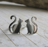 Small cat earrings with long curled tail. Handmade in sterling silver or 14k gold.