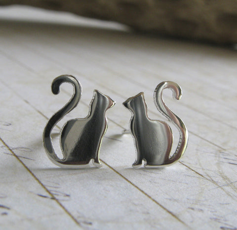 Small cat earrings with long curled tail. Handmade in sterling silver or 14k gold.