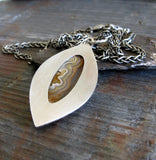 Sterling Silver marquise pendant with sand colored gemstone on gray stone