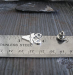 deer rack tie tack pin shown on ruler and gray tile