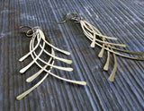 long wire dangle earrings on gray stone
