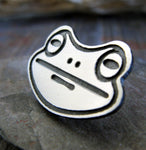 Frog Face silver tie tack on rock