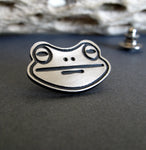 Frog Face silver tie tack on black background with driftwood