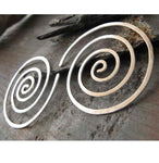 Spiral hoop earrings on gray stone