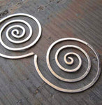 Spiral hoop earrings on gray stone
