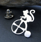 Silver Circus Monkey on Tricycle tie tack pin on dark background