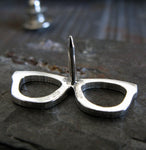 Back side of silver glasses pin on gray stone