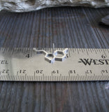 serotonin molecule tie tack on a silver ruler and gray stone