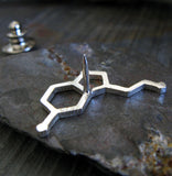 back side of silver serotonin molecule tie tack pin