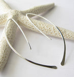 Silver wirework spike earrings on white background with starfish