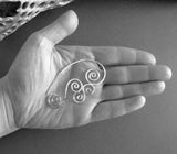 Sterling Silver Triskele Spiral wirewok earrings in human hand