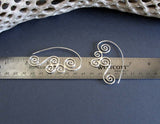 Sterling Silver Triskele Spiral wirewok earrings on ruler for measurement