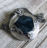 Dark blue Moss Agate pendant on wood grain