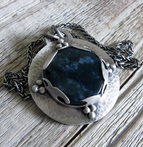 Dark blue Moss Agate pendant on wood grain