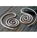 silver spiral earrings on gray stone