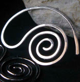 Spiral earring on black background with rock