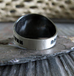 Sterling Silver Ring Shown from Back on Stone Gray with Tree Branch