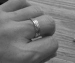 Three thin rings shown on hand in black and white