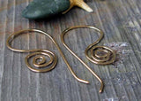 gold wire spiral earrings on gray stone tile