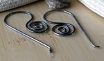 oxidized silver spiral wire earrings on tan wood