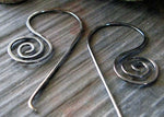 dark silver spiral wire earrings on gray stone