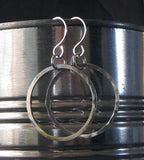 hanging silver hoop earrings on silver tin can