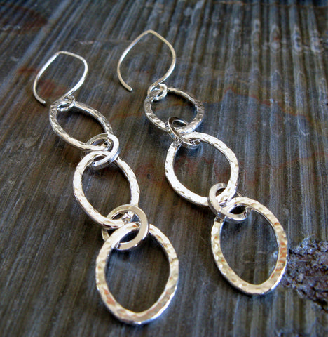 silver oval dangle earrings on gray stone