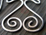 Close up of silver spirals on gray tile