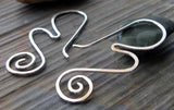 Silver wave and spiral wire earrings on gray stone