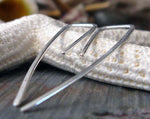 Silver Line Stick earrings on white starfish and gray stone